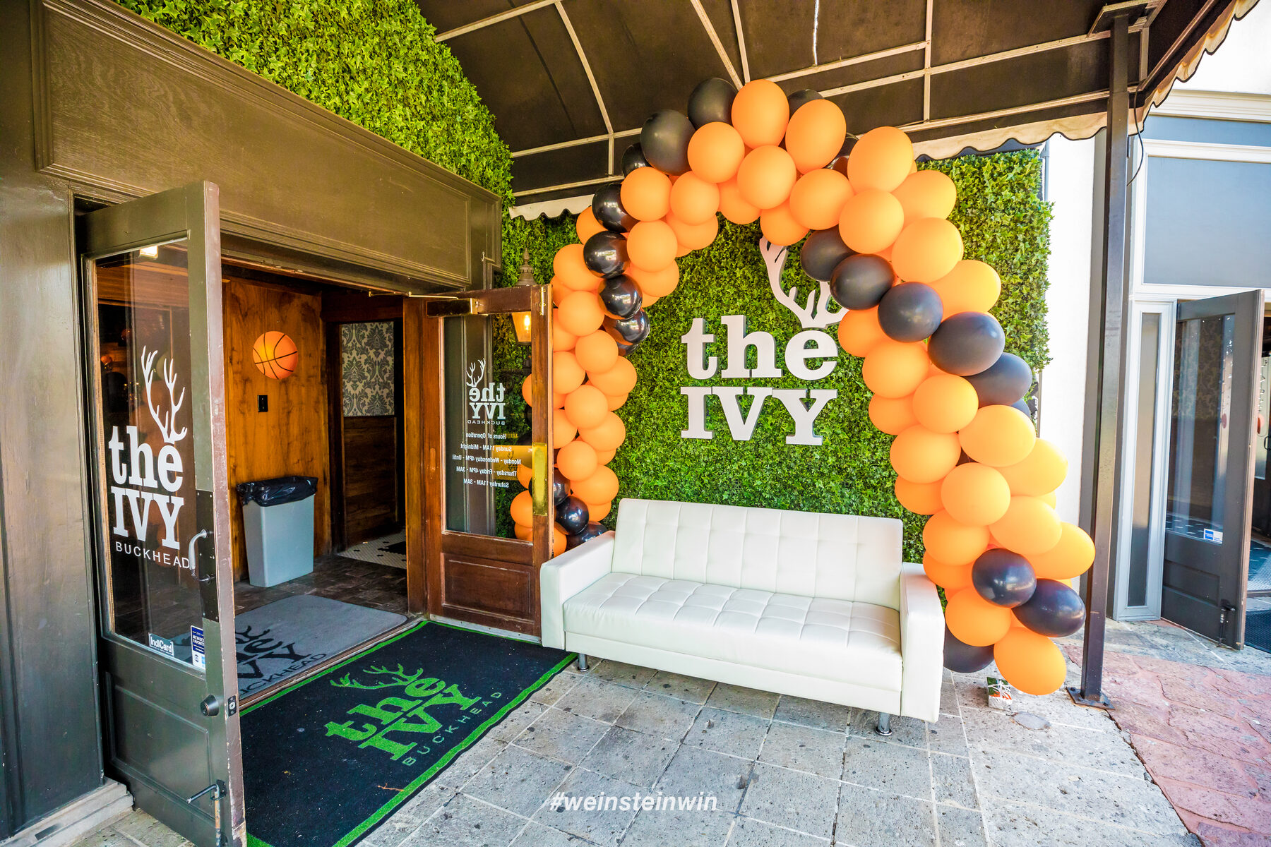 Entryway with balloon installation for a law firm Final Four party