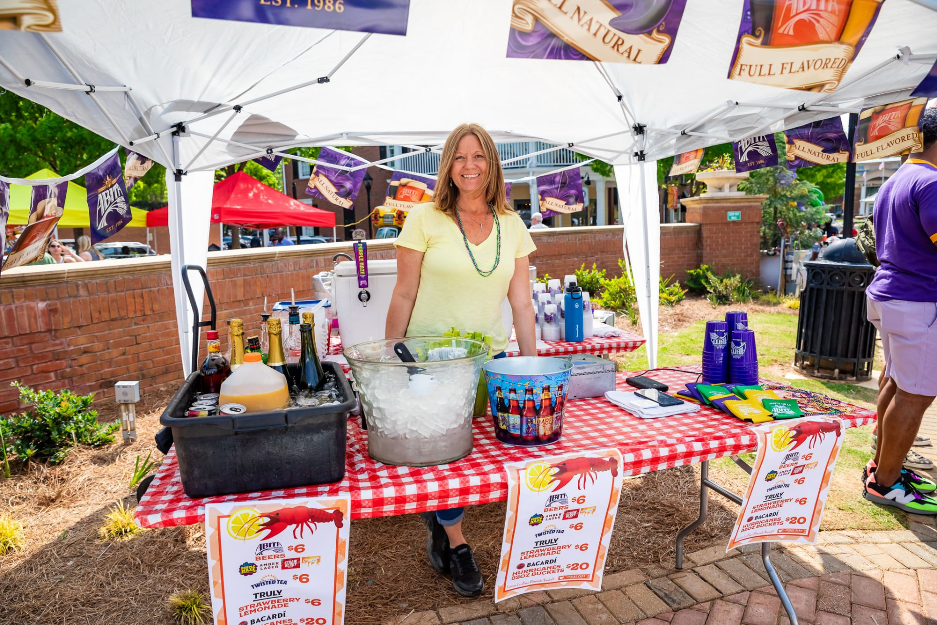 Festival bar tent with staff serving beer and cocktails